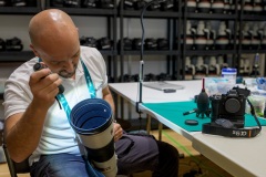 Luca Cibelli cleans a 600mm lens at the Sony Service Centre in Milan at the Milan Cortina 2026 Winter Olympics.