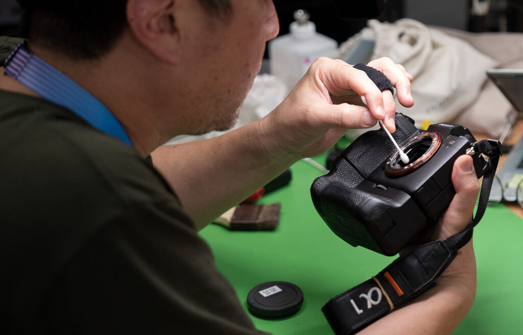 Sensor cleaning at the Main Press Center. Photo by Nick Didlick